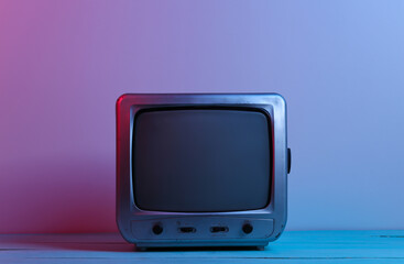 Old tv receiver in red blue neon light. Retro wave, media