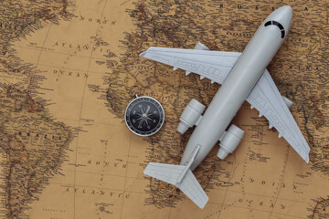 Compass and air plane on old map. Travel, adventure concept