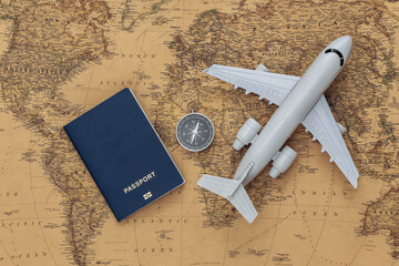 Compass and air plane, passport on old map. Travel, adventure concept