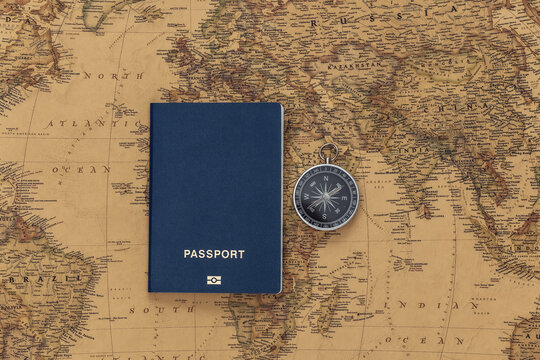 Compass and passport on old map. Travel, adventure concept