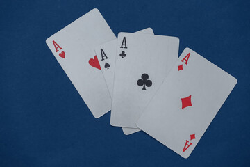 Four aces on classic blue background.