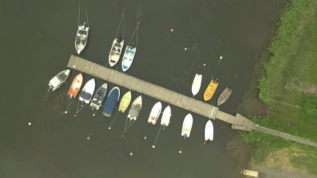 Boats moored at pier, aerial top down view rotaing footage