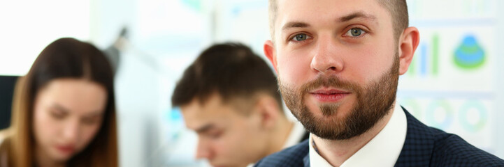 Obraz premium Young smiling clerk in suit and tie looking in camera headshot