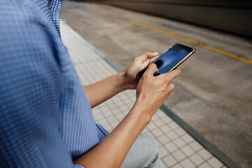 a Businessman Using Mobile Phone in the City. Cropped image, selective focus on Smartphone