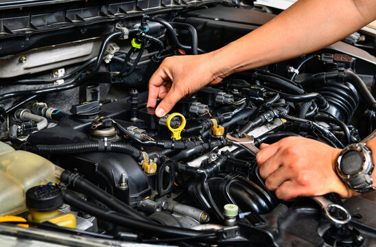 A professional mechanic checking car engine.