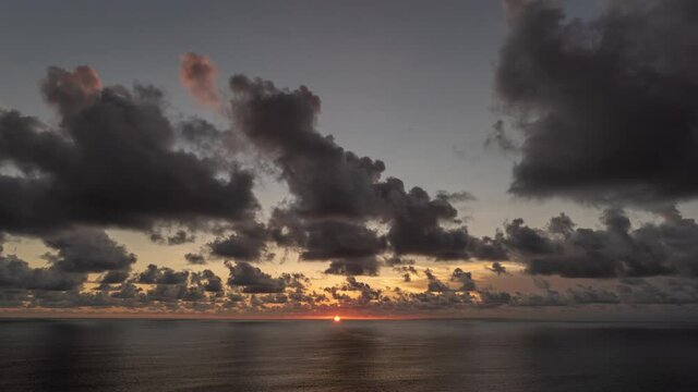 Bali Indonesia Cloudy Sunset on the cliff looking to the ocean Time Lapse