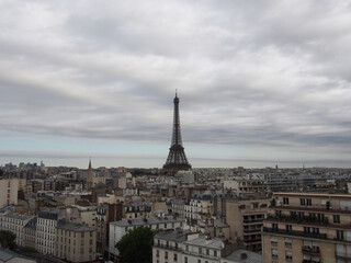 Paris skyline and Eiffel Tower on a cloudy day with thick clouds.