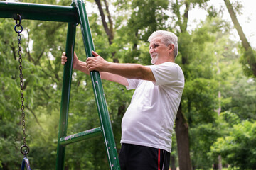 Senior man stretching in park