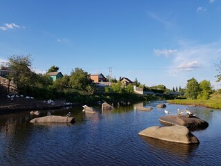 Large stone boulders lie in the river