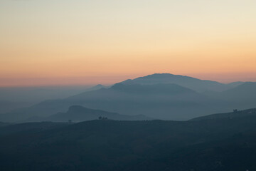Lovely yellow color of a sunset with some mountains