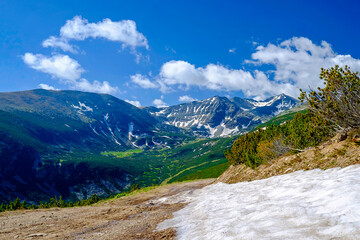 Road with Snow Mountains View in Summer 2