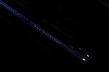 闇を走る新幹線　Japanese bullet train running in the night city