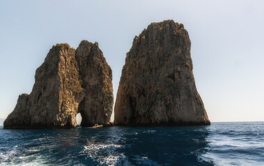 Fototapeta na wymiar The main acctraction of Capri coast, the faraglioni, Gulf of Naples.
