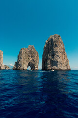 Amazing clear and lightblue sea and sky around the faraglioni of Capri.