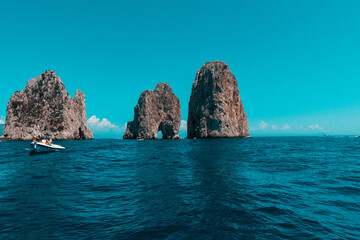 Amazing and romantic view of Faraglioni the symbol of the island of Capri, Gulf of Naples, Italy.