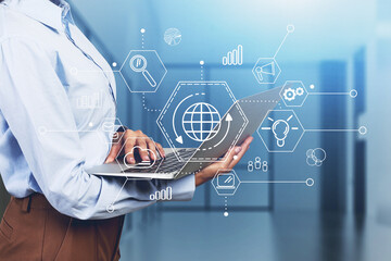 Woman with laptop in office, cloud computing