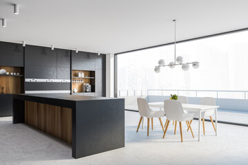 Black kitchen corner with bar, table and balcony