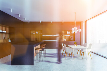 African woman in black and wooden kitchen