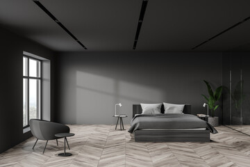 Grey master bedroom interior with armchair