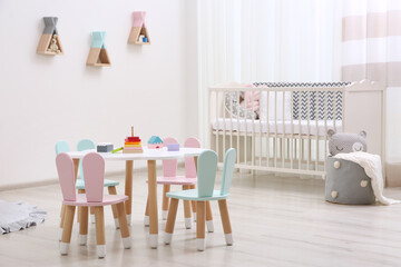 Cute baby room interior with cot and little table