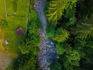 drone shot out in nature of river, bridge and green trees. Copy