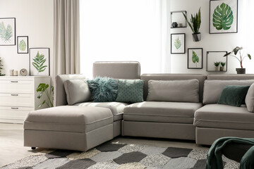 Comfortable large sofa in light room. Interior design