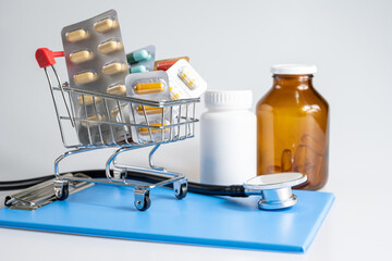 Medicine, vitamins and antioxidant supplements in trolley or cart delivery and drug bottle on white background