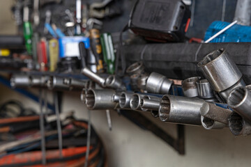 Fototapeta na wymiar Close up A lot of socket wrench and tools at mechanic shop.