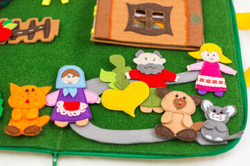Obraz na płótnie Canvas Educational felt book with wooly fairy tale toys for little children. Leisure and early development concept.