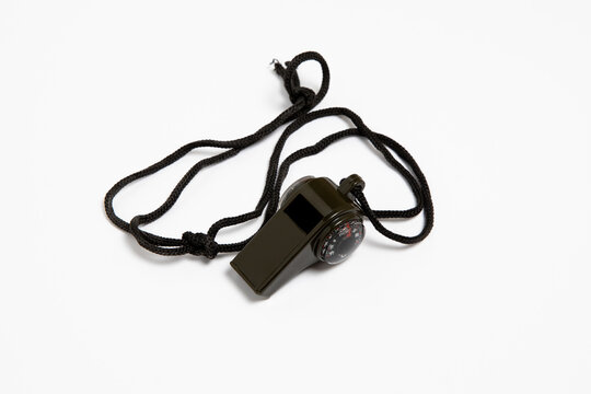 Black sports whistles isolated on white background. High-resolution photo.