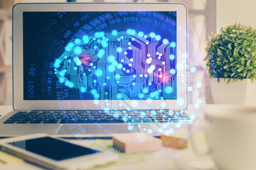 Double exposure of work space with computer and human brain drawing hologram. Brainstorm concept.