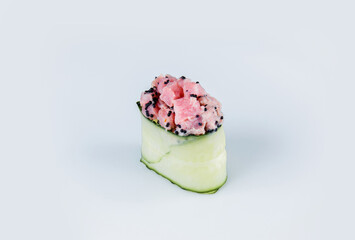 Japanese Gunkan Green Sushi with Tobiko caviar, rice and tuna wrapped in cucumber. Side view Pan Asian dish Gunkan Maki isolated on gray background. Kappa Maguro nigiri with Japanese mayonnaise
