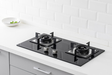 close up of gas stove in white modern kitchen.