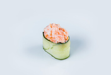 Japanese Gunkan Green Sushi with salmon, cream cheese. Gunkan-poppy with rice, Philadelphia cheese and salmon wrapped in cucumber. Side view Pan Asian dish Gunkan Sake Maki isolated on gray background