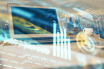 Computer on desktop in office with technology theme hologram. Multi exposure. Tech concept.