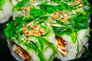 Rolls with fish, cheese and green algae. A traditional Japanese dish. Close up.