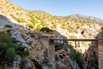 El Caminito del Rey, Spain, old narrow dangerous metal bridge spread between rocks over the precipice at El Chorro gorge. Bridge is destroyed and closed for tourists. 