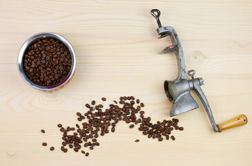 Moka pot with coffee beans and hot espresso on a wooden background. The Coffee lover concept. Czech Republic, Europe.
