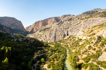 Fototapeta na wymiar Mountain landscape view of El Chorro narrow gorge at El Caminito del Rey walkway with wild river. Spain.