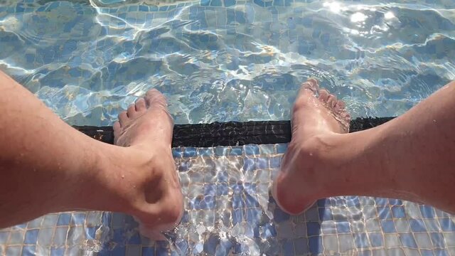 feet in the pool turning off the summer heat