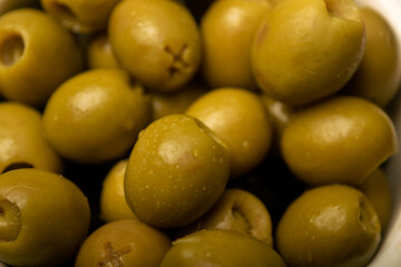 Green olives, the texture of the surface. Close up.
