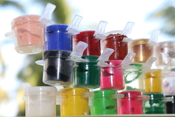 three steps of multi-color water paints or poster paints with colors like pink, white, black, green, gold, silver