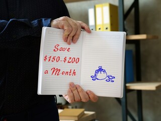 Business concept about Save $150-$200 A Month with inscription on the sheet.