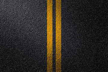 Top view of Double yellow lines on asphalt street roadway surface texture background.