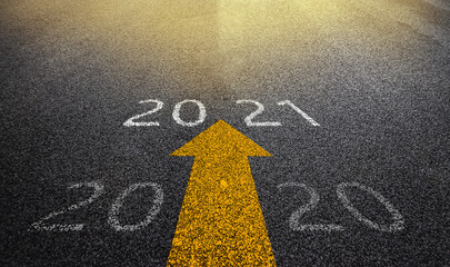 New Year 2021 Concept : Empty asphalt street road and writing text 2020 and 2021 on roadway.