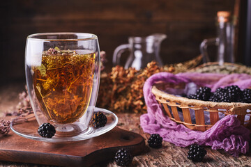 Herbal and flower tea. Blackberry on a wooden background
