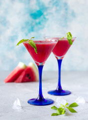 Glasses with watermelon smoothie and fresh mint leaves, healthy refreshing drink