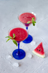 Two glasses with watermelon smoothie with fresh mint, healthy refreshment and detox drink
