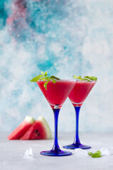 Watermelon smoothie with fresh mint in martini glasses. tasty summer drink. Copy space, vertical orientation