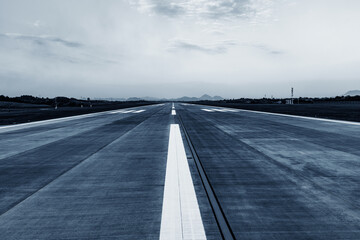 Runway, airstrip in the airport terminal with marking on blue sky